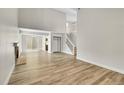 Spacious living room with fireplace, wood floors, and staircase access at 3890 S Atchison Way # B, Aurora, CO 80014