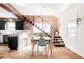 Bright dining room features hardwood floors, exposed brick, and an open staircase at 4452 Stuart St, Denver, CO 80212