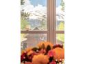 Scenic mountain view through a window with an eye-catching bouquet of flowers in the foreground at 105 S High St # A, Breckenridge, CO 80424