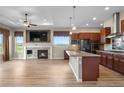 Bright, open-concept living space with fireplace, modern kitchen, and expansive windows overlooking scenic views at 2600 Reserve Ct, Erie, CO 80516