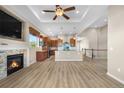 Inviting open-concept design with a cozy fireplace, modern kitchen, and staircase leading to upper level at 2600 Reserve Ct, Erie, CO 80516
