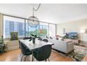 Bright living room with dining area, large windows, and comfortable seating at 3100 E Cherry Creek South Dr # 303, Denver, CO 80209
