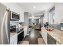 Well-lit kitchen featuring white cabinets, granite countertops, and stainless steel appliances at 2562 E 90Th Pl, Thornton, CO 80229