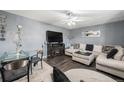 Cozy living room featuring a modern fireplace, a plush sectional sofa, and stylish decor at 2562 E 90Th Pl, Thornton, CO 80229