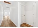 Bright hallway with hardwood floors, white walls, and recessed lighting at 9283 Biscay St, Commerce City, CO 80022
