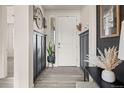 Stylish entryway with wainscoting, light wood floors, and decorative accents at 840 Avena Dr, Elizabeth, CO 80107