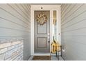 Charming front door with decorative wreath, sidelight, and welcoming doormat at 840 Avena Dr, Elizabeth, CO 80107