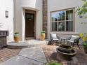 Inviting home entrance with outdoor seating, a tiered fountain, and brick-paved walkway at 9266 E 35Th Ave, Denver, CO 80238