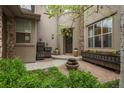 Beautiful front courtyard featuring lush greenery, a stone fountain, and a welcoming entryway at 9266 E 35Th Ave, Denver, CO 80238