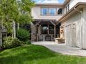 Backyard patio includes stone columns, a pergola, and a tiered fountain, perfect for outdoor enjoyment at 9266 E 35Th Ave, Denver, CO 80238