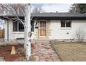 Front view of a single-story home with a stone pathway and a well-maintained lawn at 5646 Jellison St, Arvada, CO 80002