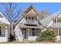 Charming two-story home featuring a small front porch and upper-level balcony at 3139 N Vine St, Denver, CO 80205