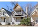 Charming two-story home featuring a small front porch and upper-level balcony at 3139 N Vine St, Denver, CO 80205