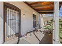 Enclosed front porch featuring a security door and a small bench and window at 3139 N Vine St, Denver, CO 80205