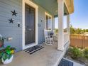 Cozy front porch with rocking chairs, decorative stars, and a welcoming 'hello' doormat, creating a charming entrance at 10 N Quantock St, Aurora, CO 80018