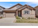 Charming single-Gathering home with stone accents, a two-car garage and manicured landscaping at 13912 Ashgrove Cir, Parker, CO 80134