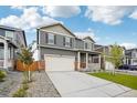 This two-story home has a well-maintained lawn, a two-car garage, and complementary landscaping at 715 N Amory St, Watkins, CO 80137