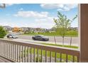 Peaceful street view from the porch showcases the well-kept neighborhood and community park across the street at 715 N Amory St, Watkins, CO 80137