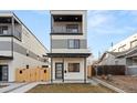 Modern two-story home with gray and white exterior, covered porch, balcony, and contemporary design at 1719 Grove St, Denver, CO 80204