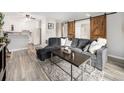 Comfortable living room featuring modern decor, a sectional sofa, and an open layout to the kitchen at 6930 E Girard Ave # 304, Denver, CO 80224