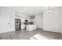 A modern kitchen is complete with stainless steel appliances, white cabinets, and an island at 487 Interlocken Blvd # 410, Broomfield, CO 80021