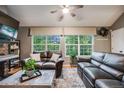 Comfortable living room with large windows, hardwood floors, leather sofas, and a decorative rug at 8337 S Upham Way # 103, Littleton, CO 80128