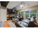 Cozy living room with a brick fireplace, vaulted ceilings, large windows, and comfortable seating at 8337 S Upham Way # 103, Littleton, CO 80128