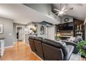 Open-concept living area with wood floors and gray walls at 8337 S Upham Way # 103, Littleton, CO 80128