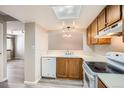 Simple kitchen with light wood cabinets, appliances, and vinyl flooring at 10490 W Jewell Ave # D, Lakewood, CO 80232