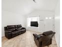 Bright living space with tile floors, neutral walls, and comfortable leather seating at 1748 Eagle St # B, Aurora, CO 80011