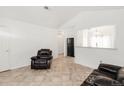 Bright living space with tile floors, neutral walls, and comfortable leather seating at 1748 Eagle St # B, Aurora, CO 80011