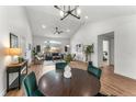 Spacious living room with vaulted ceilings, wood floors, modern decor, and easy access to other rooms at 4043 E Geddes Cir, Centennial, CO 80122