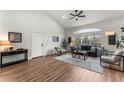 Cozy living room with wood floors, a modern sofa, stylish chairs, and a bright window at 4043 E Geddes Cir, Centennial, CO 80122