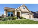 Attractive home featuring stone accents and manicured landscaping at 15619 Syracuse Way, Thornton, CO 80602