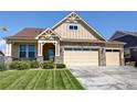 Inviting home with stone accents, a three-car garage, and lush green lawn at 15619 Syracuse Way, Thornton, CO 80602
