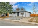 A lovely home with a manicured gravel front yard and inviting curb appeal at 12801 Randolph Pl, Denver, CO 80239