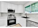 The kitchen has stainless appliances, a modern faucet and beautiful white countertops at 12801 Randolph Pl, Denver, CO 80239