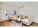 Bright living room featuring a comfortable sectional sofa and hardwood floors at 4418 Utica St, Denver, CO 80212