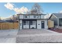 Charming home featuring a modern design with black framed windows, a well-maintained yard, and a private wooden fence at 4835 Grove St, Denver, CO 80221