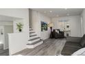 Bright living room featuring new floors and a staircase, creating a modern and comfortable space at 4835 Grove St, Denver, CO 80221