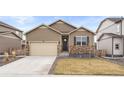 Charming single-Gathering home with neutral siding, stone accents, a two-car garage, and a well-manicured lawn at 2326 Monte Vista St, Fort Lupton, CO 80621