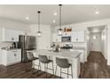 Modern kitchen features a center island, granite countertops, stainless steel appliances, and white cabinetry at 2326 Monte Vista St, Fort Lupton, CO 80621