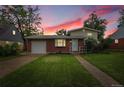Charming brick home with a well-maintained lawn and landscaping at 1330 Quari St, Aurora, CO 80011