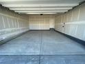 Spacious garage with painted drywall and concrete flooring ready for storage and parking at 16552 E 109Th Ave, Commerce City, CO 80022