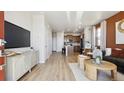 An open-concept living space, showcasing modern furnishings and connecting seamlessly with the kitchen at 22272 E 7Th Pl, Aurora, CO 80018