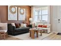 A stylish living room with comfortable seating, natural light, and decorative art pieces on the walls at 22272 E 7Th Pl, Aurora, CO 80018