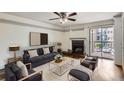 Cozy living room featuring a fireplace, balcony access, and comfortable seating arrangements at 4899 S Dudley St # 15G, Littleton, CO 80123