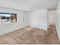 Bright living room with neutral walls, carpet and large window at 1584 S Salem Cir, Aurora, CO 80012