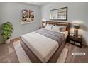 Serene main bedroom with a plush bed, side tables, and soft lighting with large window at 1584 S Salem Cir, Aurora, CO 80012