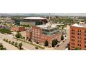 An aerial view showcases the building's architecture and the vibrant cityscape at 1143 Auraria Pkwy # 203, Denver, CO 80204